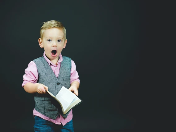 Surprised child holding a book