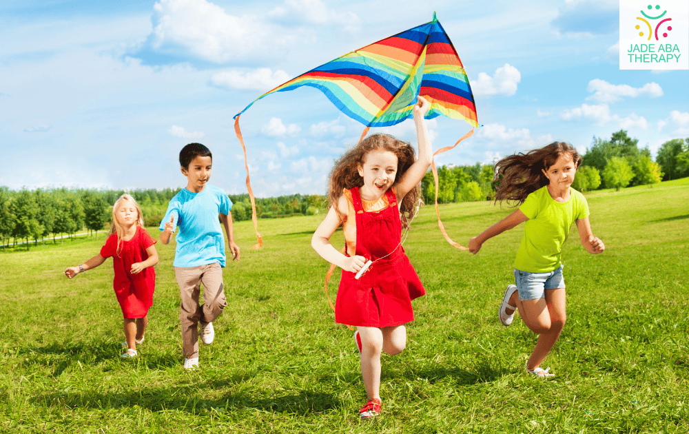 Children flying a colorful kite in a field