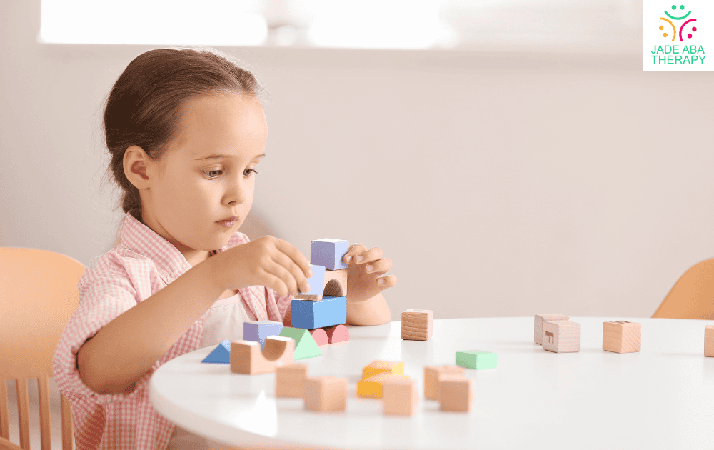 Child playing with colorful building blocks at a table